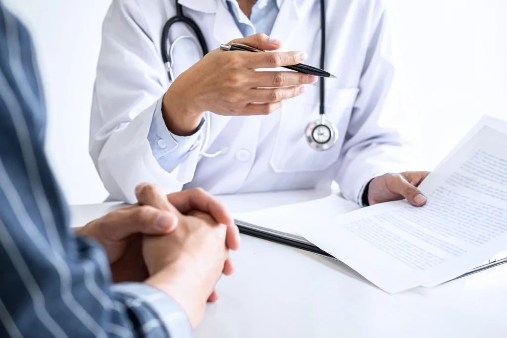 Doctor reviewing paperwork with a patient across a desk
